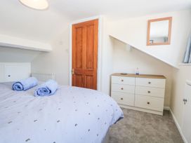 A bedroom with a bed and chest of drawers at Yewbarrow in Seascale