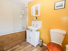 A bathroom with a bathtub and sink at Yewbarrow in Seascale
