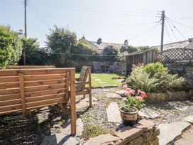 A garden with seating area and flower pot at Yewbarrow in Seascale