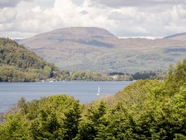A view of a lake with a sailing boat and mountains at Yewbarrow Seascale