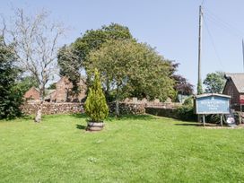 An outdoor area with a sign and trees at Gosforth Hall Inn Seascale