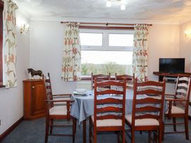 A dining room featuring a table and chairs at The Bungalow in St. Austell