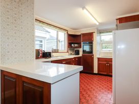 A kitchen with cabinets and appliances at The Bungalow in St. Austell