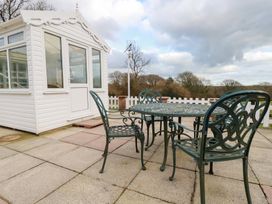A conservatory and outdoor seating area at The Bungalow in St. Austell