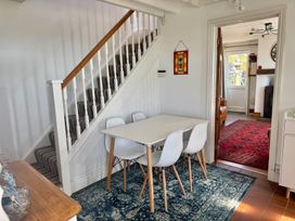 A dining room with a table and chairs at Penpegws near Aberystwyth