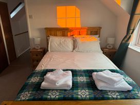 A bedroom with a bed and bedside tables at Penpegws near Aberystwyth