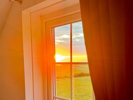 A window with a sunset view at Penpegws near Aberystwyth