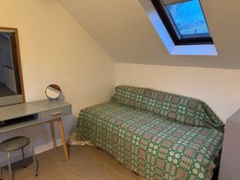 A bedroom with a bed and desk at Penpegws near Aberystwyth