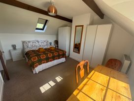 A bedroom with a bed and table at Penpegws near Aberystwyth