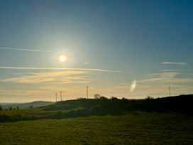 A landscape view featuring sun and hills at Penpegws near Aberystwyth