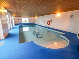 An indoor pool with steps and a lifebuoy at Cliff Cottage
