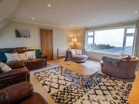 A living room with sofas and a coffee table at Cliff Cottage