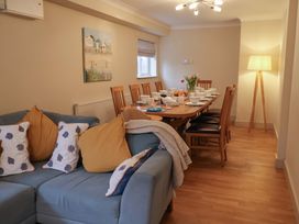A dining room with a table set for a meal at Cliff Cottage
