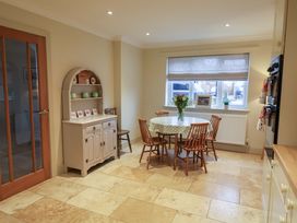 A kitchen with a dining table and chairs at Cliff Cottage