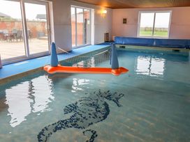 An indoor swimming pool with a pool float at Cliff Cottage