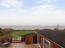 An outdoor view of the sea and patio area at Cliff Cottage