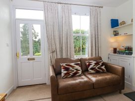 A living room with a sofa and shelves at 8 Railway Cottages in Ulverston