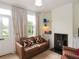 A living room with a sofa and fireplace at 8 Railway Cottages Ulverston
