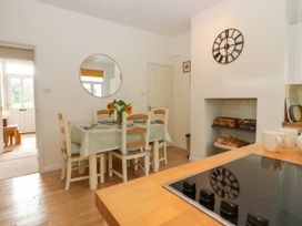 A dining room with a table and chairs at 8 Railway Cottages in Ulverston