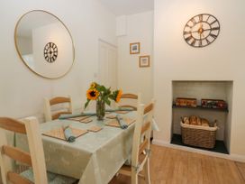 A dining room with a table and chairs at 8 Railway Cottages in Ulverston