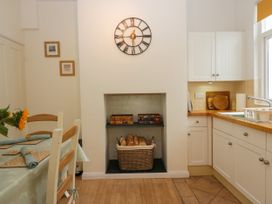 A kitchen with a dining table and chairs at 8 Railway Cottages Ulverston