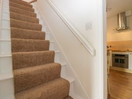 A staircase leading to a kitchen area at 8 Railway Cottages in Ulverston