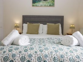 A bedroom with a bed and pillows at 8 Railway Cottages Ulverston