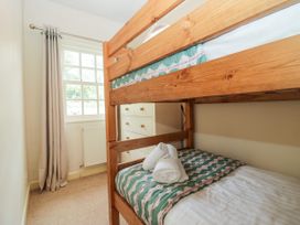 A bedroom with a bunk bed and a dresser at 8 Railway Cottages in Ulverston