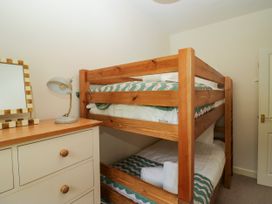 A bedroom with a bunk bed and a dresser at 8 Railway Cottages Ulverston