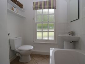 A bathroom with a toilet, sink, and bathtub at 8 Railway Cottages in Ulverston