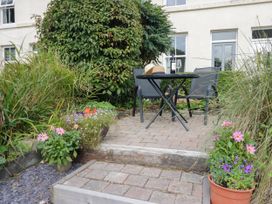 A garden area with a table and chairs at 8 Railway Cottages Ulverston