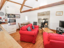 A living room with a sofa and fireplace at Dove Cottage in Hexham