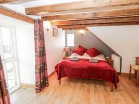 A bedroom with a bed and window at Dove Cottage in Hexham