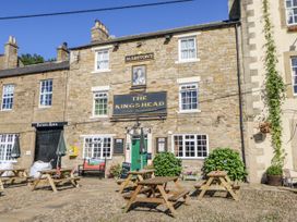An outdoor area with seating in front of The Kings Head in Hexham