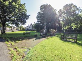 A park with benches and a monument at Dove Cottage in Hexham