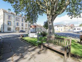 An outdoor area with a bench and road signs at Dove Cottage in Hexham