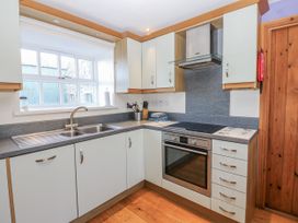 A kitchen with cabinets and a stove at Swallows Rest in Hexham