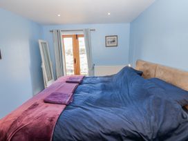 A bedroom with a bed and window at Swallows Rest in Hexham