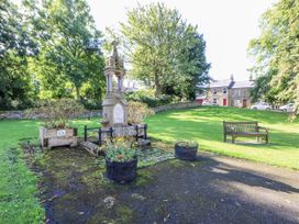 A memorial surrounded by grass and trees at Swallows Rest in Hexham