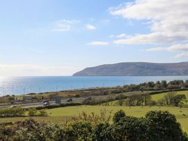 A coastal view with a road and hills at Orme View in Penmaenmawr