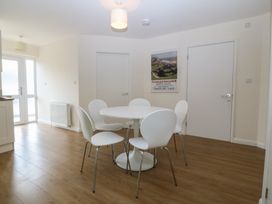 A dining room with a table and chairs at Orme View in Penmaenmawr