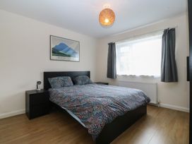 A bedroom with a bed and nightstand at Orme View in Penmaenmawr
