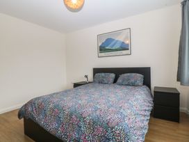 A bedroom with a bed and nightstand at Orme View in Penmaenmawr
