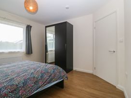 A bedroom with a bed and wardrobe at Orme View in Penmaenmawr