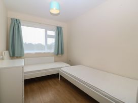 A bedroom with two beds and a window at Orme View in Penmaenmawr