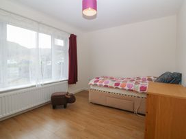 A bedroom with a bed and a window at Orme View in Penmaenmawr