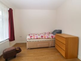 A bedroom with a bed and a dressing table at Orme View in Penmaenmawr