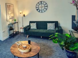 A living room with a sofa and coffee table at 20 Bridge Street in Morpeth