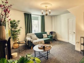 A living room with a sofa and table at 20 Bridge Street in Morpeth