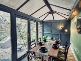 A dining setup with a table and chairs in a conservatory at 20 Bridge Street Morpeth